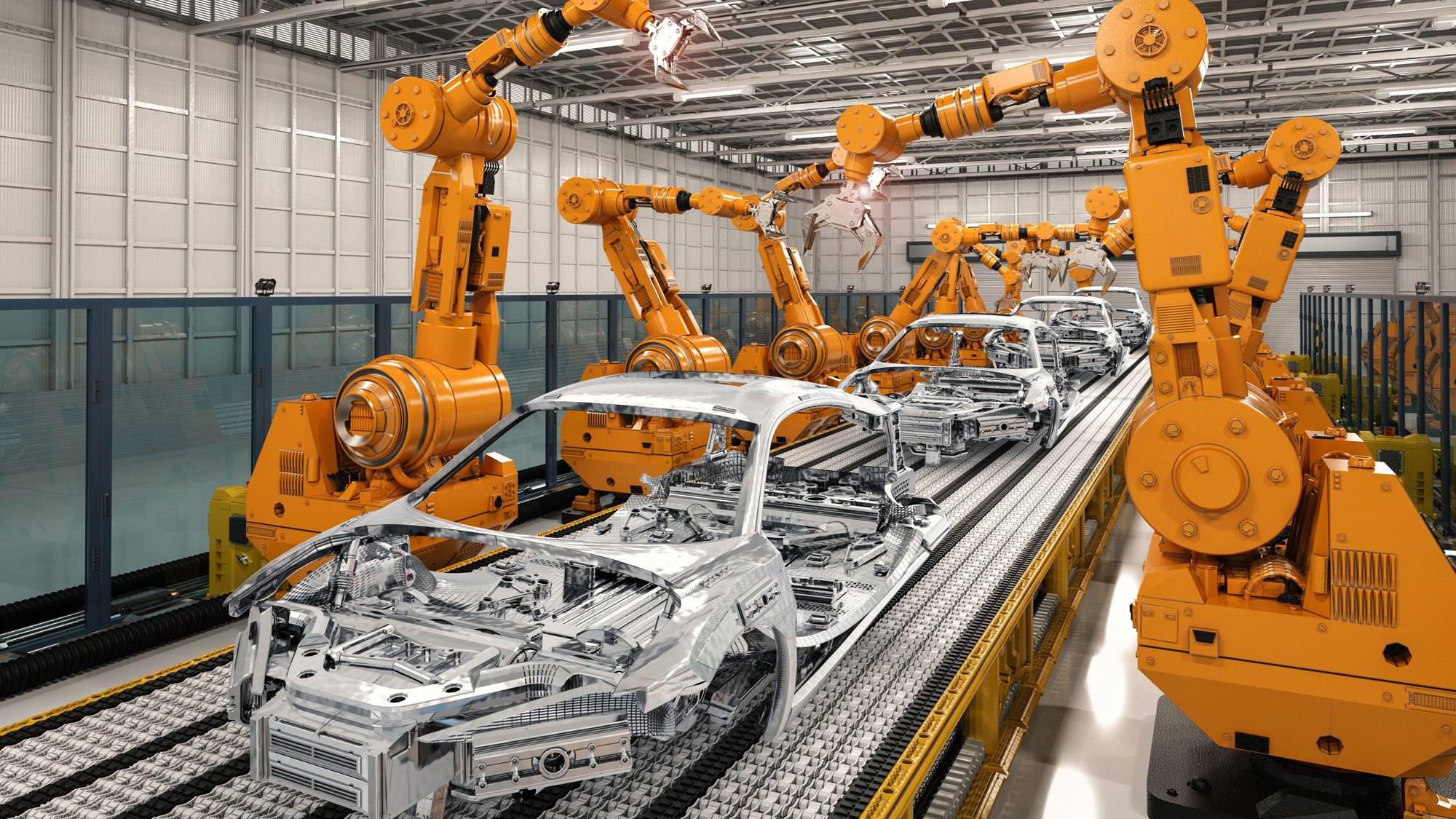 Orange robot arms working on a bare car body moving along an assembly line